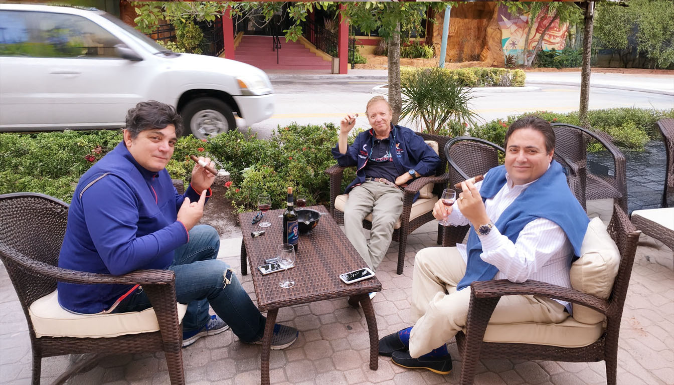 Sseating outside patio of Cuenca Cigars smoking non-Cuban Cigars. Rafael Nodal, Javier Estades and Miguel A Cuenca